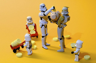 stormtroopers loading piggy banks with coins