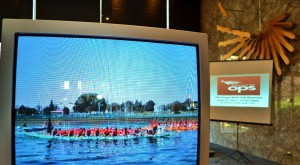 OPSDBC-2012-Showcase-showing-video-of-dragon-boat-with-presentation-in-background-300x165